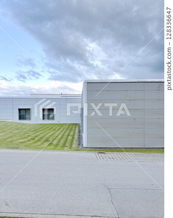 Grey building with a grey wall and a grey roof 128336647