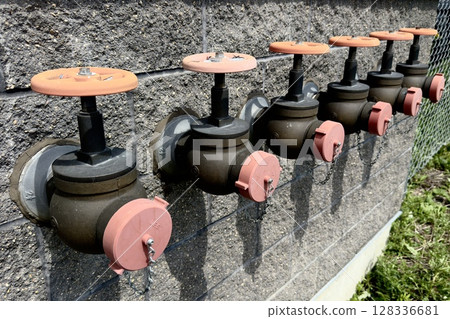 industrial valves with handles on the wall industrial valves with handles on the wall 128336681