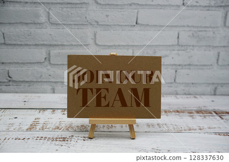 Join Our Team text message with easel stand on wooden background 128337630