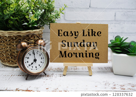 Enjoy like Sunday Morning text message with easel stand on wooden background 128337632