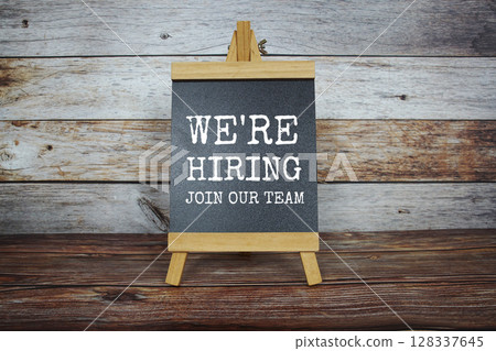We are hiring and Join our Team text message on blackboard stand on wooden background We are hiring and Join our Team text message on blackboard stand on wooden background 128337645