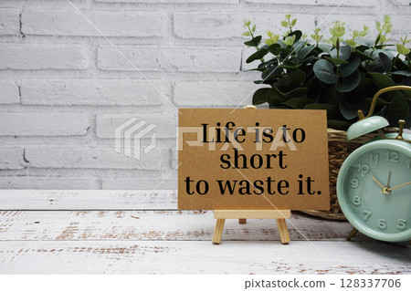 Life is to short to waste it text message with easel stand on wooden background Life is to short to waste it text message with easel stand on wooden background 128337706