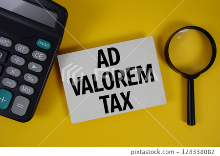 Ad Valorem Tax text with magnifying glass anc calculator on yellow background 128338082