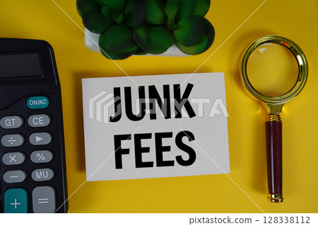 Junk fees text with magnifying glass anc calculator on yellow background Junk fees text with magnifying glass anc calculator on yellow background 128338112