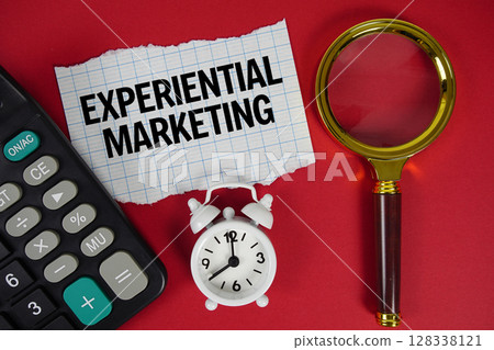 Experiential Marketing text with alarm clock, magnifying glass anc calculator on red background 128338121