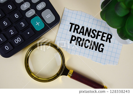 Transfer Pricing text with magnifying glass anc calculator on yellow background 128338243