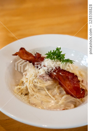 Spaghetti Carbonara with ham and bacon served on a white plate. Soft Focus. Spaghetti Carbonara with ham and bacon served on a white plate. Soft Focus. 128338828