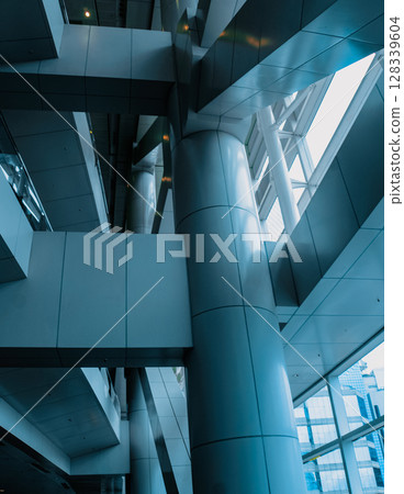 Modern building's interior with large windows and blue glass panels 128339604