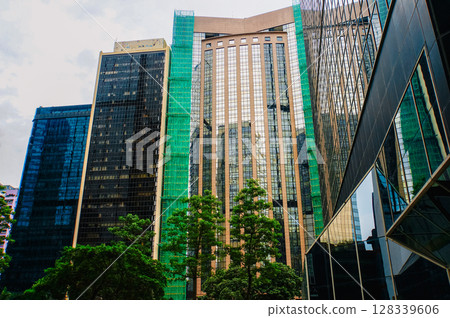 A modern skyscraper reflects sky with its glass facade A modern skyscraper reflects sky with its glass facade 128339606