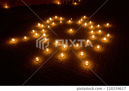 Evening Candle Arrangement Sparkles on Cobblestone Patio Illuminating Serenity 128339617