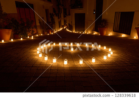 Enchanting Night Scene of Candlelit Pathway in Village Street 128339618