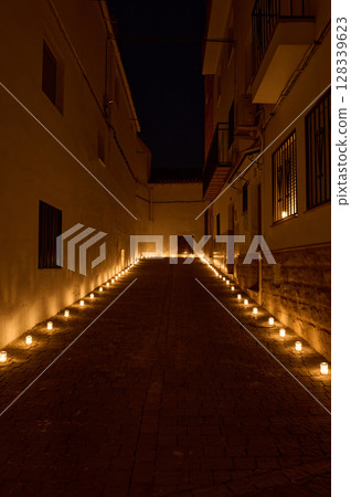 Tranquil Night Alleyway Illuminated by Aligned Candle Lights Tranquil Night Alleyway Illuminated by Aligned Candle Lights 128339623