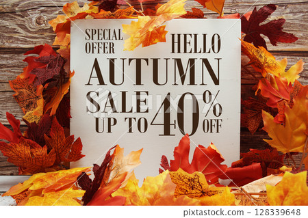 Autumn Sale 40% off text with maple leaf decoration on wooden background Autumn Sale 40% off text with maple leaf decoration on wooden background 128339648