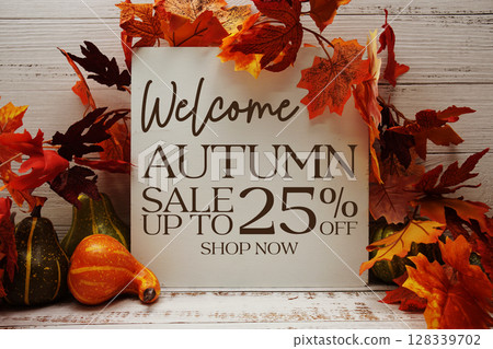 Autumn Sale 25% off text with maple leaf decoration on wooden background Autumn Sale 25% off text with maple leaf decoration on wooden background 128339702