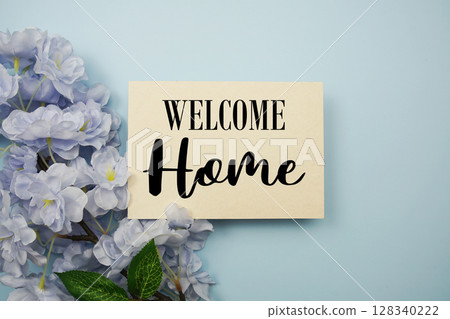 Welcome Home text with flowers decoration on light blue background 128340222