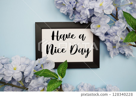 Have a Nice Day text with flowers decoration on light blue background Have a Nice Day text with flowers decoration on light blue background 128340228