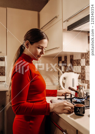 Woman Kitchen Coffee Brewing: Evening Home Routine, Turkish Coffee Preparation Woman Kitchen Coffee Brewing: Evening Home Routine, Turkish Coffee Preparation 128340354