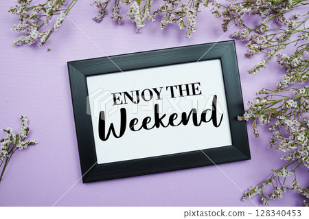 Enjoy The Weekend text with flowers bouquet decoration on purple background 128340453