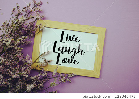 Live Laugh Love text with flowers bouquet decoration on purple background 128340475