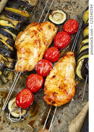 BBQ chicken and roasted vegetables in baking sheet. 128340594
