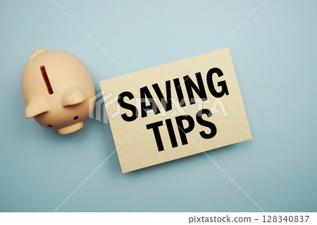 Saving Tips text and piggy bank for saving on blue background 128340837