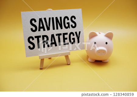 Savings Strategy text and piggy bank for saving on yellow background 128340859