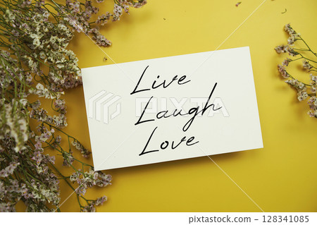 Live Laugh Love text with flowers decoration on yellow background Live Laugh Love text with flowers decoration on yellow background 128341085