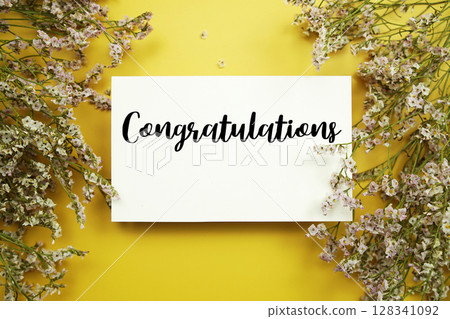 Congratulations text with flowers decoration on yellow background 128341092