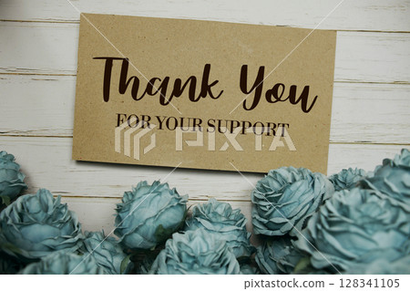 Thank You text on paper card with rose flowers bouquet on wooden background Thank You text on paper card with rose flowers bouquet on wooden background 128341105