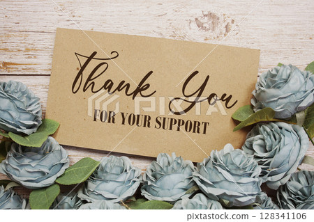 Thank You text on paper card with rose flowers bouquet on wooden background Thank You text on paper card with rose flowers bouquet on wooden background 128341106