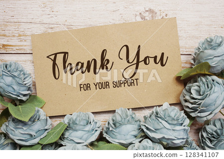 Thank You text on paper card with rose flowers bouquet on wooden background Thank You text on paper card with rose flowers bouquet on wooden background 128341107