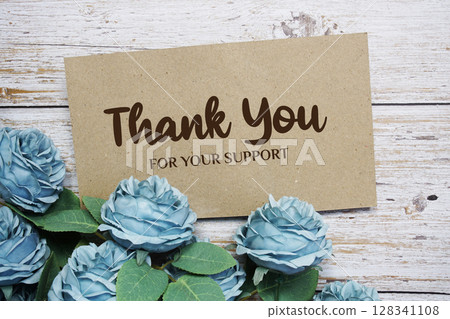 Thank You text on paper card with rose flowers bouquet on wooden background Thank You text on paper card with rose flowers bouquet on wooden background 128341108