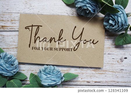 Thank You text on paper card with rose flowers bouquet on wooden background Thank You text on paper card with rose flowers bouquet on wooden background 128341109