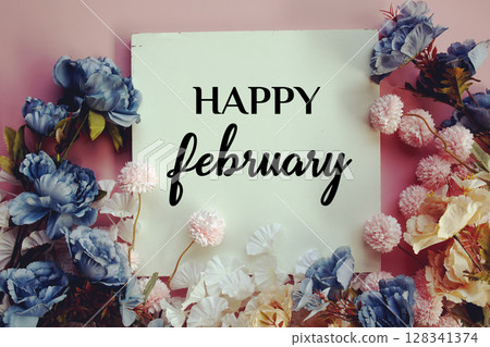 Happy February text with flowers decorations on pink background 128341374
