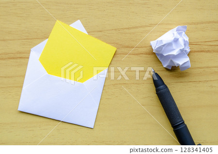 Top view of white notepad with envelope and crumpled paper with customizable space for text or ideas Top view of white notepad with envelope and crumpled paper with customizable space for text or ideas 128341405
