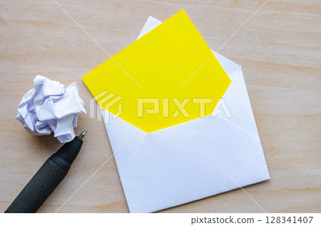 White notepad with envelope a pen and crumpled paper with customizable space for text or ideas. Resignation concept White notepad with envelope a pen and crumpled paper with customizable space for text or ideas. Resignation concept 128341407