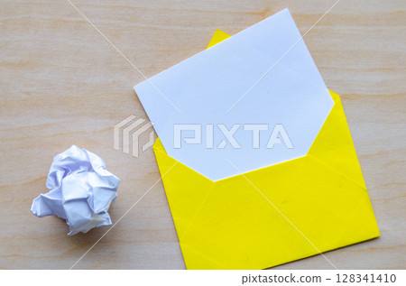 Top view of white notepad with envelope and crumpled paper with customizable space for text or ideas. Top view of white notepad with envelope and crumpled paper with customizable space for text or ideas. 128341410