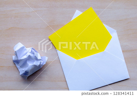 Top view of white notepad with envelope crumpled paper with customizable space for text. Resignation concept Top view of white notepad with envelope crumpled paper with customizable space for text. Resignation concept 128341411