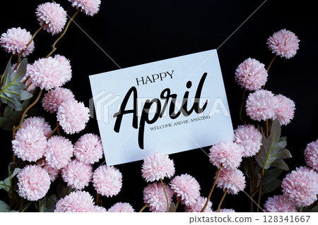 Happy April Welcome and be amazing text with flowers decorations on black background 128341667