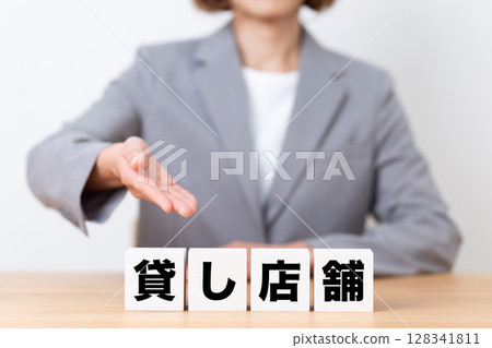 一家租賃商店街區和一位身穿西裝的中年女女商人 128341811