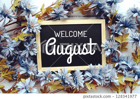 Welcome August text with flowers frame decoration top view on wooden background, 128341977