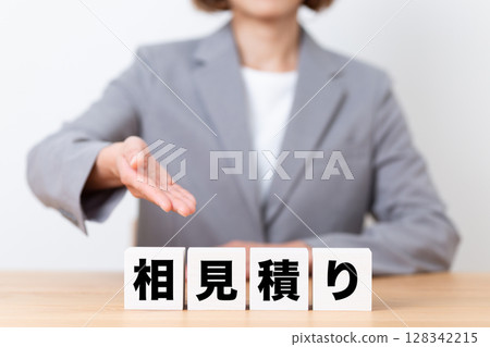 A middle-aged female business woman wearing a suit and a block of competitive bids 128342215
