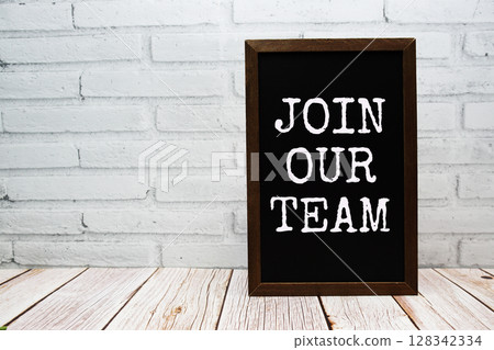 Join our team text written on chalkboard standing on wooden background 128342334