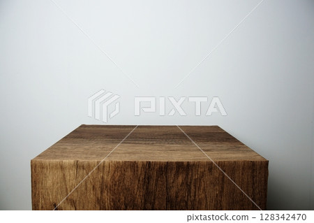 Empty wooden podium stand for display products front of concrete background Empty wooden podium stand for display products front of concrete background 128342470