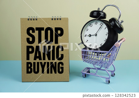 Stop Panic Buying wiht mini trolley shopping cart and alarm clock on blue and yellow background Stop Panic Buying wiht mini trolley shopping cart and alarm clock on blue and yellow background 128342523