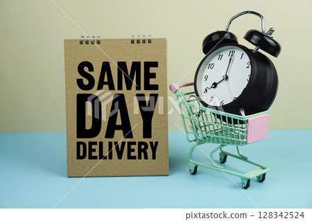 Same Day Delivery wiht mini trolley shopping cart and alarm clock on blue and yellow background 128342524