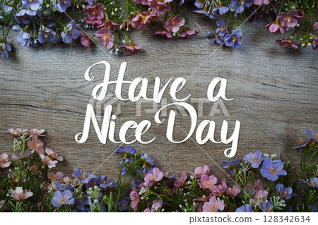 Have a nice day text message with flowers decoration on wooden background Have a nice day text message with flowers decoration on wooden background 128342634