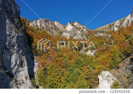 Aerial view of rocky limestone mountains and autumn forest 128342638