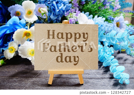 Happy father's day text write on paper card with wooden easel and flowers decoration on wooden background 128342727