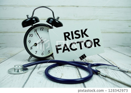 Risk Factor text on paper card with alarm clock and stethoscope on wooden background 128342973